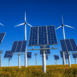 Wind turbines and solar panels generating renewable energy under a clear blue sky.