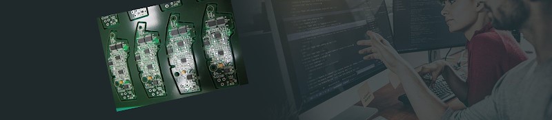 Populated printed circuit board assemblies with an engineer reviewing design files on monitors